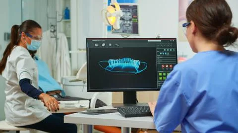 Dentist assistant writing parameters from digital dental fingerprint Stock Photos