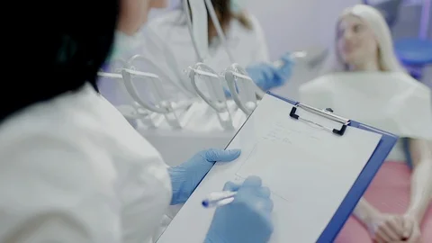 Dentist assistent develops a patient's schedule Stock Footage 104346807