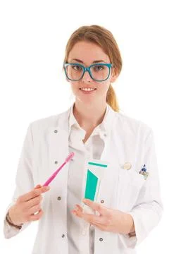 Dentist with brush and tooth paste Female dentist with tooth paste and bru... Stock Photos