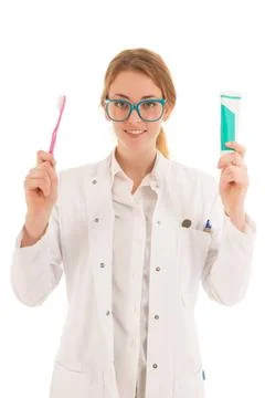 Dentist with brush and tooth paste Female dentist with tooth paste and bru... Stock Photos