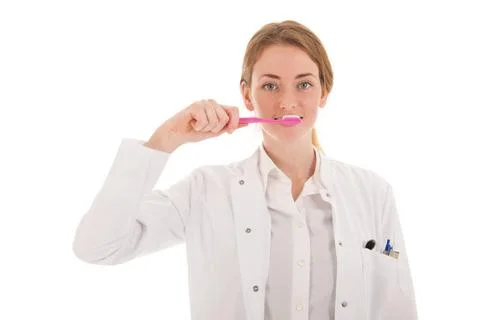 Dentist with brush and tooth paste Female dentist with tooth paste and bru... Stock Photos