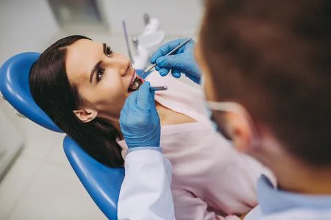 Dentist checking patient teeth Stock Photos