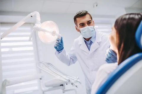 Dentist checking patient teeth Stock Photos