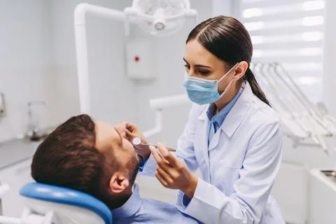 Dentist checking patient teeth Stock Photos
