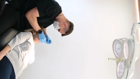 A dentist checks the condition of old teeth. A doctor examines the teeth of an Stock Footage 222810450