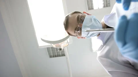 The dentist checks the mouth using tools. Point of view of patient in chair. Stock Footage 62133952