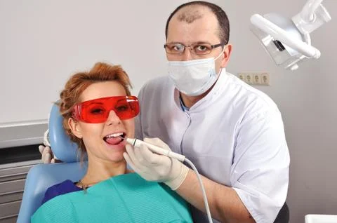 Dentist cleans teeth Stock Photos