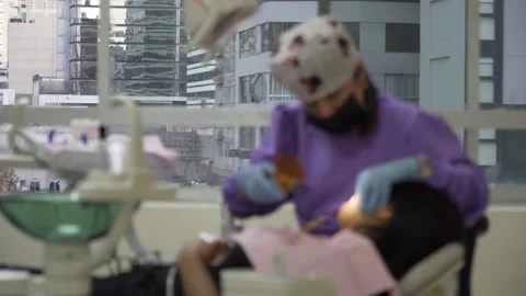 Dentist curing teeth and using dental curing light Video stock 201263934