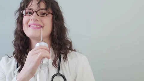 Dentist demonstrates proper use of an electric irrigator for cleaning teeth with Stock Footage 307305226
