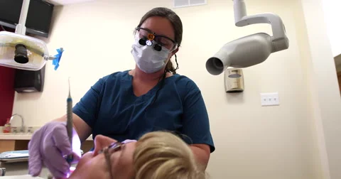 Dentist Doing a Cleaning Low Angle Stock Footage 57753499