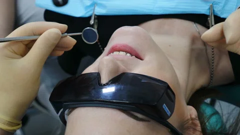 Dentist doing injection to his patient in dental clinic. Close up of Dentist Stock Footage 105144100