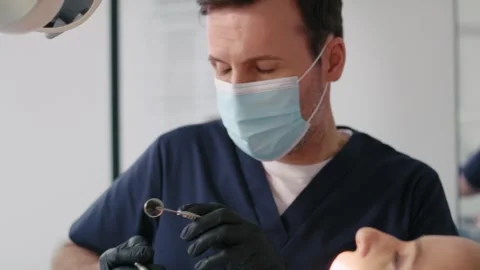 Dentist during routine visit with the patient Stock Footage 274141040