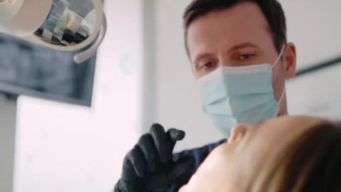 Dentist during routine visit with the patient Video stock 274141042