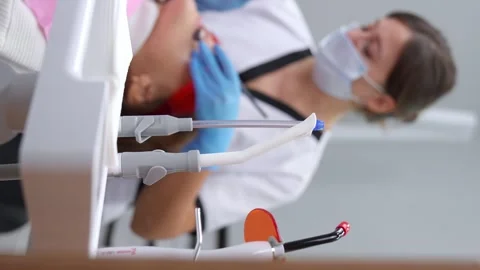 Dentist examines his patient's teeth during appointment at dental clinic 스톡 동영상 258747719