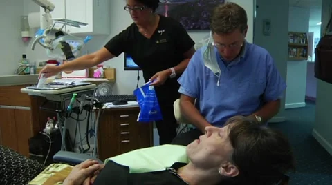 Dentist examines patient Stock Footage 8653360