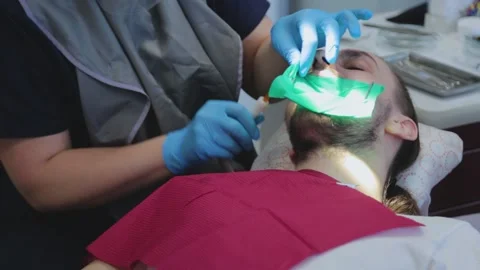 The dentist examines the patient's teeth with a special dental mirror. Stock Footage
