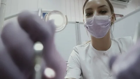 Dentist examines the teeth of patient with angular probe in stomatology clinic Stock Footage 81818763