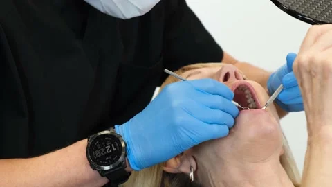 The dentist examines the teeth using sterile dental instruments. Modern dental Stock-Footage 222810365