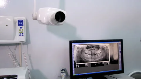 Dentist examines X-ray picture of patient teeth on computer Stock Footage 239434134