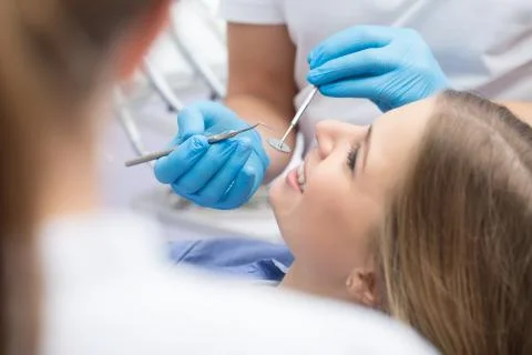 Dentist examining a patient's teeth in the dentist 스톡 사진