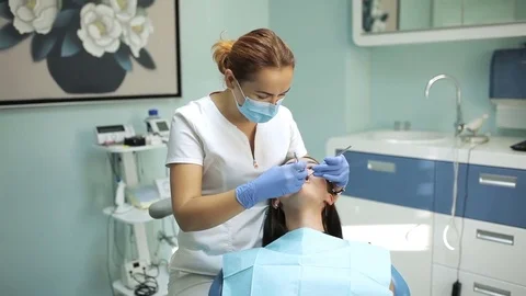 Dentist examining a patient's teeth in the dentistry Stock Footage