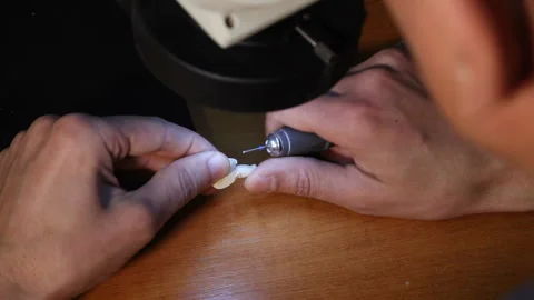 Dentist explaining artificial teeth to patient in clinic office. Stock Footage 87395975