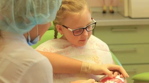 Dentist explaining to child how right brush your teeth Stock Footage 68497118