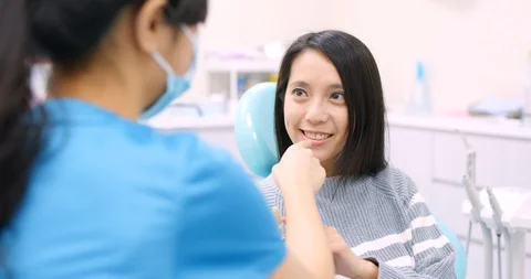 Dentist explaining the implant tooth to the patient Stock Footage 85727140