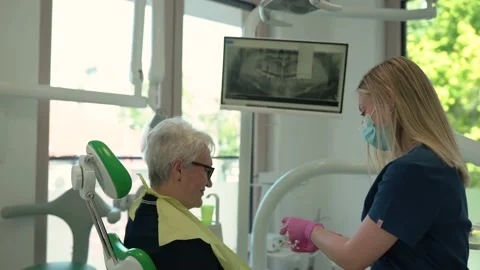 Dentist explaining using a dental model and tools. Stock Footage 156571420