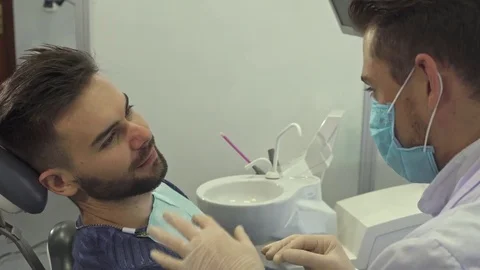 Dentist explains something to his client Stock Footage 76524548