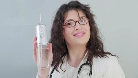 Dentist explains why an irrigator is an essential tool for maintaining healthy Stock Footage 307304958