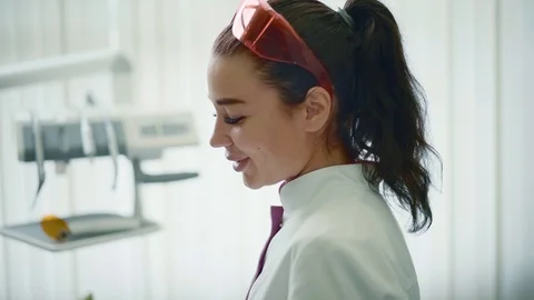 Dentist explaning her work to a patient in dental office Stock Footage 94352634