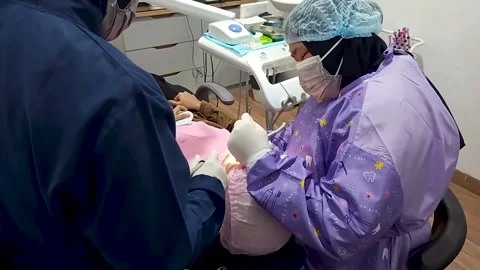 Dentist with face covered with a mask Stock Footage 299683639