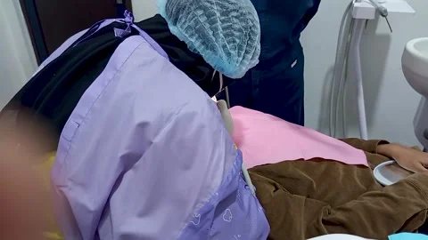 Dentist with face covered with a mask Stock Footage 299683814