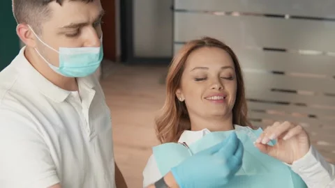 The dentist focuses on a professional approach to bite correction. The patient Stock Footage 252131977