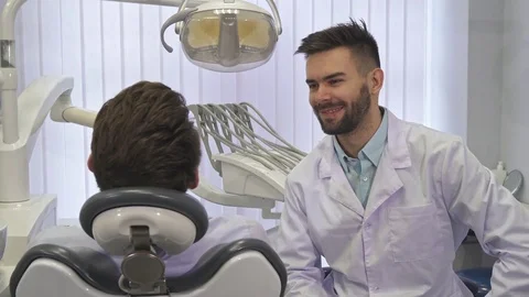 Dentist gives mirror to the client Stock Footage 76520774