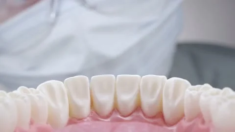 Dentist in glasses inspecting teeth 動画素材 139685104