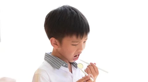 Dentist hand checking Young Thai boy teeth by equipment  Stock Footage 68082380