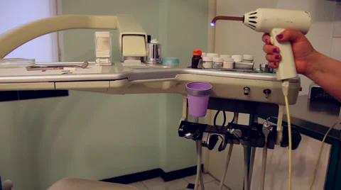 Dentist hand using a dental curing light, lamp, dental office, dental care Stock Footage 38105100