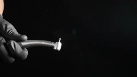 Dentist hands in black gloves with working drill illustrating surgical operation Video stock 126553241