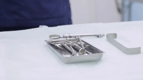 Dentist hands in blue gloves touching sterilized instruments Stock Footage 76240544