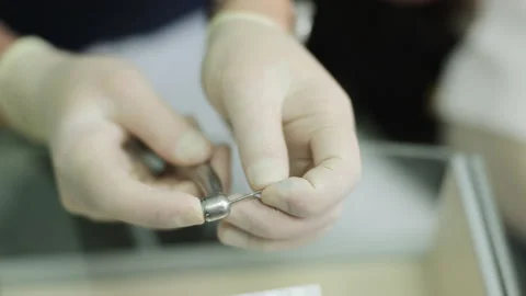Dentist hands in gloves using dental equipment. Dentist using a drill machine Stock Footage 194461470
