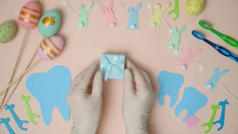 Dentist hands holding gift on Easter day, top view. Stock Footage 263726994