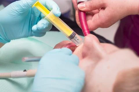 Dentist injected with a syringe to patient's teeth Stock Photos