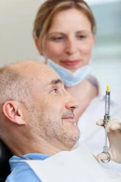 Dentist injecting anesthesia Stock Photos