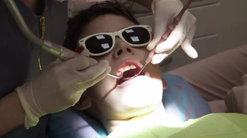 Dentist inspecting checked a child's teeth Stock Footage 158446914
