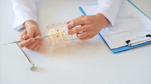 Dentist with instruments and false teeth Video stock 65775413