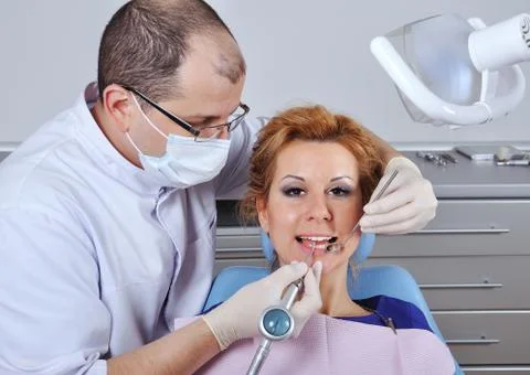 Dentist makes cleaning Stock Photos