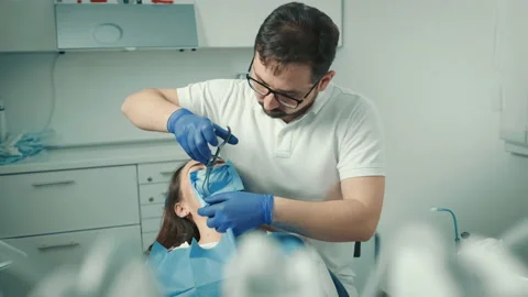 Dentist makes a procedure for teeth whitening. Beautiful smile. Ultraviolet lamp Stock Footage 152244030