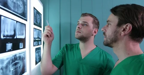 Dentist Men Talking Analyze X Rays Diagnostic Teamwork Activity in Dental Clinic Stock Footage 88034278